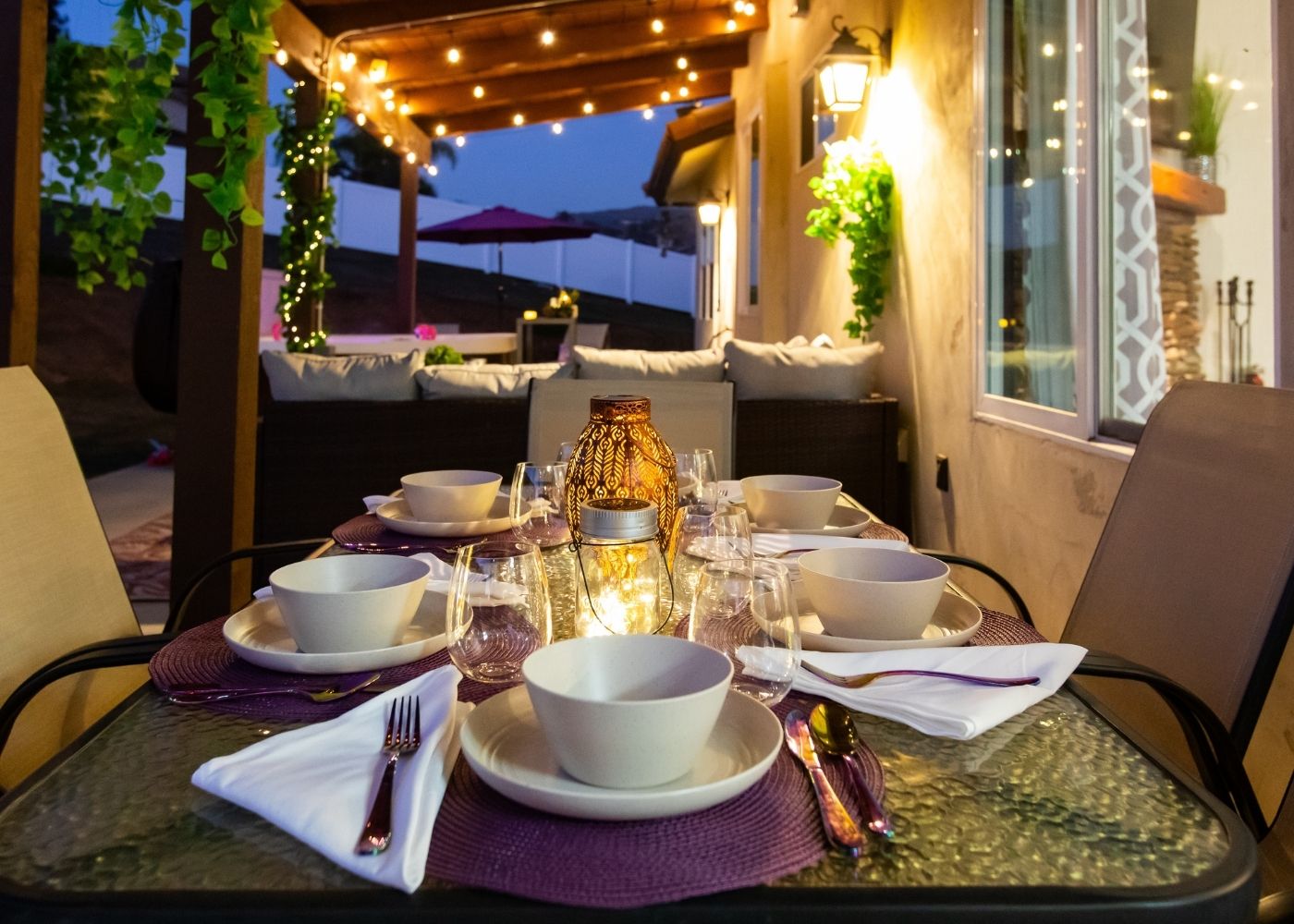 Covered patio dining area with string lights at Hearth